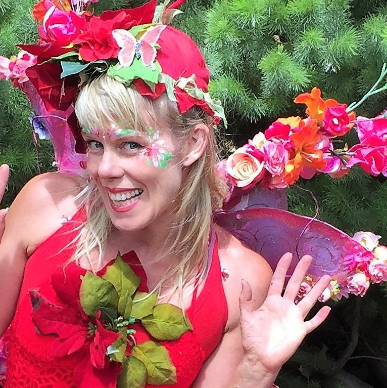 A woman dressed as a fairy posing for a photo.