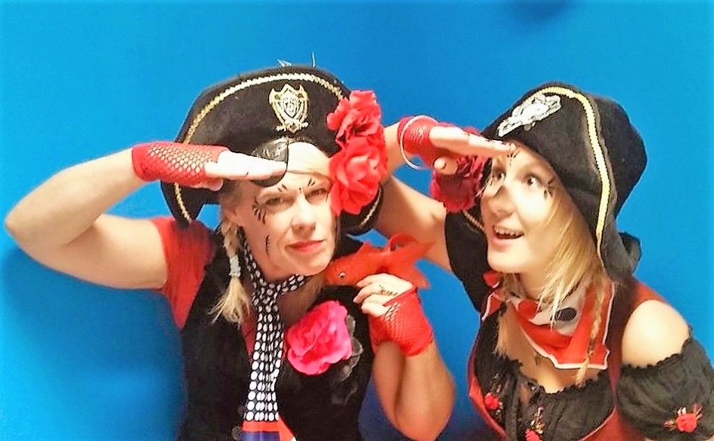 Two women wearing pirate clothing.