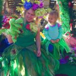 A woman and a child dressed up as mermaids.