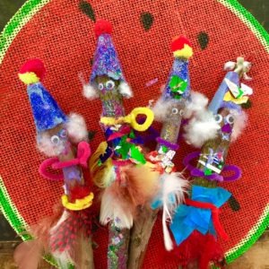 A group of sticks with different hats on them.