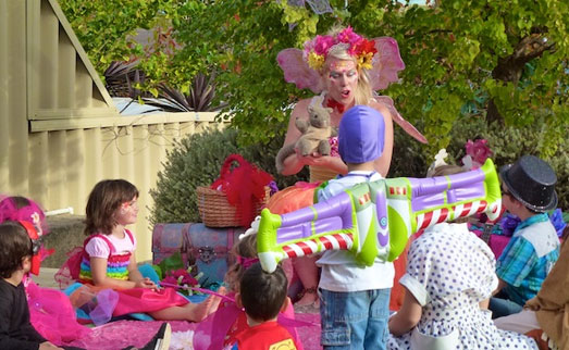 A woman wearing a garment and holding a toy.