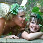 A woman and a girl in fairy clothing.