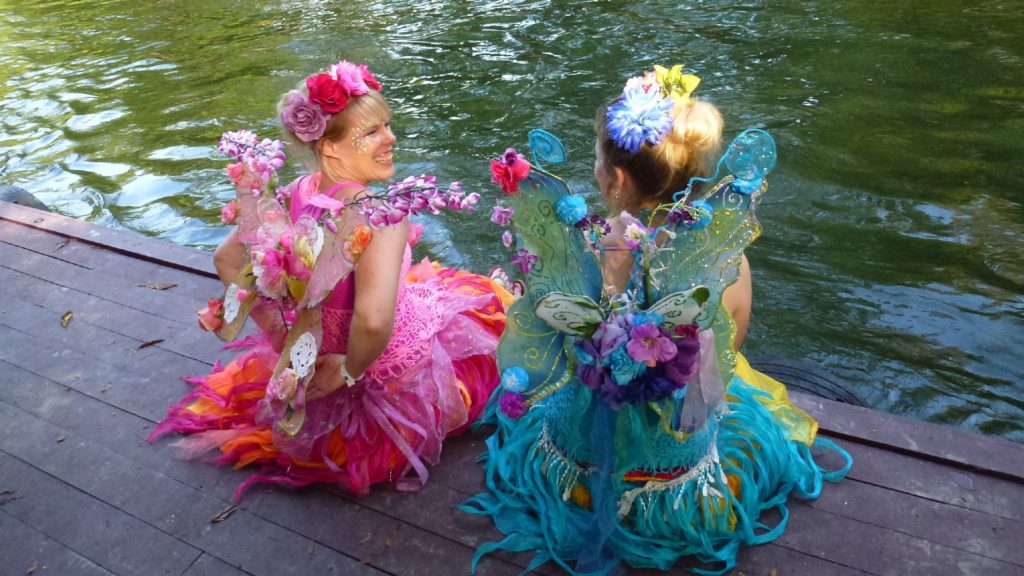 A couple of women wearing fairy clothing.