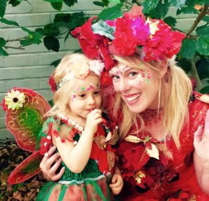 A woman and a child dressed up in fairy clothing.