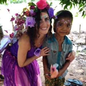 A woman dressed as a fairy poses with a child.