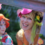 A woman holding a frame with flowers and a child in it.