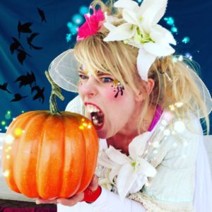 A woman holding a pumpkin.