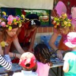 A group of children dressed in fairy costumes at a table.