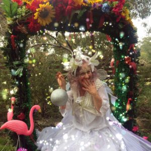 A woman dressed up in a white dress with flamingos.