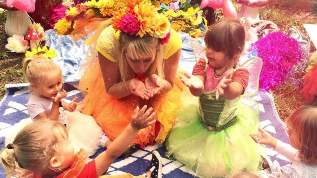 A group of children dressed up in fairy costumes.