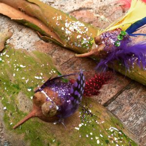 A group of feathered sticks on a table.