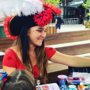 A woman wearing a pirate hat.