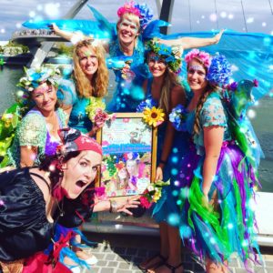 A group of women dressed in fairy costumes posing for a picture.