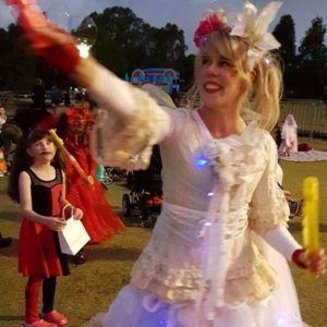 A woman dressed up in a costume and holding a balloon.